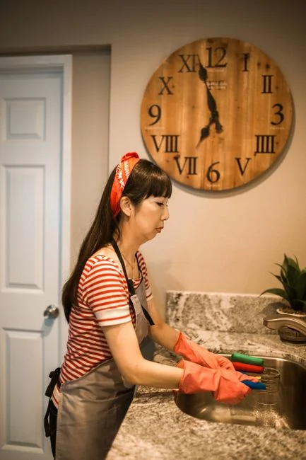 Young couple assembling furniture in their new apartment, surrounded by cardboard boxes.
